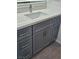 Bathroom featuring gray cabinets, drawers and doors, white countertop and flooring at 5155 W Tropicana Ave # 2089, Las Vegas, NV 89103