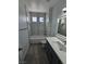 Bathroom featuring a modern vanity, stylish mirror, tub and shower combo, and accent tiles at 5155 W Tropicana Ave # 2089, Las Vegas, NV 89103