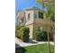 A view of the building's exterior with lush landscaping at 5155 W Tropicana Ave # 2089, Las Vegas, NV 89103