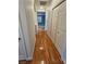 Hallway with hardwood floors, white walls, and access to multiple rooms at 5155 W Tropicana Ave # 2089, Las Vegas, NV 89103