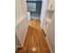 Hallway boasts wood floors leading to a living room with a window and shutters at 5155 W Tropicana Ave # 2089, Las Vegas, NV 89103
