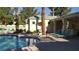 Community pool with lounge chairs and landscaping at 5155 W Tropicana Ave # 2089, Las Vegas, NV 89103