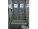 A bathroom shows a tub with white and gray modern tiling and a shower head at 5155 W Tropicana Ave # 2089, Las Vegas, NV 89103