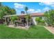 A lush backyard featuring a well-manicured lawn, charming patio area, and mature landscaping for outdoor relaxation at 5222 Joshua Jose St, North Las Vegas, NV 89031