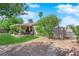Fenced backyard offers a covered patio, a lush lawn, mature trees and landscaping, offering a serene outdoor retreat at 5222 Joshua Jose St, North Las Vegas, NV 89031