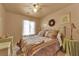 Cozy bedroom features a well-made bed with a neutral color scheme, framed pictures, and lamps on tables at 5222 Joshua Jose St, North Las Vegas, NV 89031