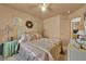 Comfortable bedroom features a neutral color scheme, a well-made bed, framed pictures, and bedside tables with lamps at 5222 Joshua Jose St, North Las Vegas, NV 89031