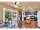 Eat-in kitchen boasts blue cabinetry, stainless appliances, and sliding door access to the backyard at 5222 Joshua Jose St, North Las Vegas, NV 89031