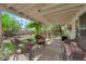Inviting covered patio with comfortable seating, perfect for enjoying the serene backyard view at 5222 Joshua Jose St, North Las Vegas, NV 89031