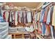 Organized walk-in closet with clothing racks, shelves, and storage containers at 5222 Joshua Jose St, North Las Vegas, NV 89031