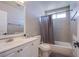 Cozy bathroom features gray tiled walls, vanity with sink, and a shower tub combo at 5301 Kalmia Dr, Las Vegas, NV 89103