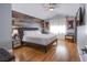 Large bedroom featuring a bed, hardwood floors, accent wall, and a ceiling fan at 5301 Kalmia Dr, Las Vegas, NV 89103