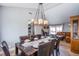 An elegant dining room featuring a large wood cabinet, dining table with 8 chairs, and stylish light fixture at 5301 Kalmia Dr, Las Vegas, NV 89103