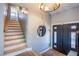 Inviting entryway with modern lighting, decorative mirror, and staircase leading upstairs at 5301 Kalmia Dr, Las Vegas, NV 89103