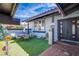 Cozy front patio with artificial turf, seating area, and decorative plants, perfect for outdoor relaxation at 5301 Kalmia Dr, Las Vegas, NV 89103