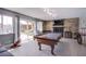 Entertainment room with a pool table, TV, and sliding glass doors overlooking the backyard at 5301 Kalmia Dr, Las Vegas, NV 89103