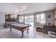 Recreation room with a pool table, tiled floors, and sliding doors leading to the backyard at 5301 Kalmia Dr, Las Vegas, NV 89103