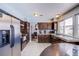 Well-lit kitchen with stainless steel appliances, dark cabinetry, granite countertops, and a spacious sink at 5301 Kalmia Dr, Las Vegas, NV 89103