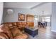 Open-concept living and dining area with vaulted ceilings, wood floors, and stylish furniture at 5301 Kalmia Dr, Las Vegas, NV 89103