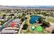 Aerial view of homes near Stallion Mountain Golf Club, with lush green fairways and water hazards at 5681 Harbour Pointe Ave, Las Vegas, NV 89122
