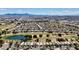 Picturesque aerial view of a residential area nestled among lush golf courses and scenic lakes at 5681 Harbour Pointe Ave, Las Vegas, NV 89122