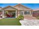 The home's backyard features an artificial turf putting green and a covered patio at 5681 Harbour Pointe Ave, Las Vegas, NV 89122