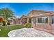 Backyard putting green with stamped concrete patio; view of the home's exterior and iron fence at 5681 Harbour Pointe Ave, Las Vegas, NV 89122