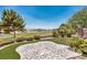Backyard putting green and stamped concrete patio with golf course views through iron fencing at 5681 Harbour Pointe Ave, Las Vegas, NV 89122