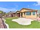 Landscaped backyard with a synthetic grass putting green, a stamped concrete patio, and desert-friendly plantings at 5681 Harbour Pointe Ave, Las Vegas, NV 89122