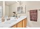 Well-maintained bathroom with double sinks, bright vanity, and a large mirror at 5681 Harbour Pointe Ave, Las Vegas, NV 89122