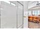 Bathroom features a glass-enclosed shower and leads into bedroom with vaulted ceiling and fan at 5681 Harbour Pointe Ave, Las Vegas, NV 89122