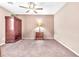 Bedroom with carpet, ceiling fan, wardrobe closet, and bedside table with a lamp at 5681 Harbour Pointe Ave, Las Vegas, NV 89122