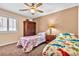Bedroom features a ceiling fan, carpet, and two twin beds with colorful bedding at 5681 Harbour Pointe Ave, Las Vegas, NV 89122