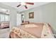 Comfortable bedroom featuring a ceiling fan, and sliding mirrored closet doors at 5681 Harbour Pointe Ave, Las Vegas, NV 89122