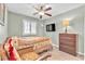 Inviting bedroom with light green walls, carpet, ceiling fan, and television at 5681 Harbour Pointe Ave, Las Vegas, NV 89122