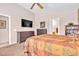 Cozy bedroom with ceiling fan, carpet flooring, and adjacent ensuite bathroom at 5681 Harbour Pointe Ave, Las Vegas, NV 89122
