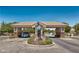 Gated community entrance featuring a sculpture and well-kept landscaping, providing security and curb appeal at 5681 Harbour Pointe Ave, Las Vegas, NV 89122
