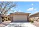 Single-Gathering home boasting a well-maintained lawn, desert landscaping, and a convenient two-car garage at 5681 Harbour Pointe Ave, Las Vegas, NV 89122