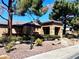 A well-maintained home featuring desert landscaping, with mature trees, and a neutral color palette at 5681 Harbour Pointe Ave, Las Vegas, NV 89122