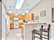 Bright and modern kitchen with light wood cabinets, white appliances, and a breakfast bar with seating at 5681 Harbour Pointe Ave, Las Vegas, NV 89122