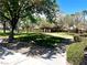 Beautiful neighborhood park with a walking path, benches, mature trees, and green space at 5681 Harbour Pointe Ave, Las Vegas, NV 89122
