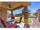 Inviting covered patio with outdoor seating and a built-in putting green for entertainment and relaxation at 5681 Harbour Pointe Ave, Las Vegas, NV 89122