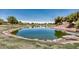 Scenic view of a tranquil pond on the golf course with surrounding greenery and rock details at 5681 Harbour Pointe Ave, Las Vegas, NV 89122