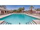 Resort-style community pool, perfect for swimming and relaxation under the sun with ample lounge chairs at 5681 Harbour Pointe Ave, Las Vegas, NV 89122