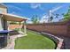Features of the backyard include artificial grass, a covered patio, and brick walls at 5904 Oakton St, Las Vegas, NV 89130