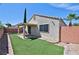 The backyard features synthetic grass, a covered patio, and brick retaining walls at 5904 Oakton St, Las Vegas, NV 89130