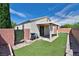 A backyard featuring an artificial lawn, a covered patio, and brick perimeter walls at 5904 Oakton St, Las Vegas, NV 89130