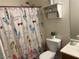 This bathroom features a decorative shower curtain, toilet, and small storage shelf at 5904 Oakton St, Las Vegas, NV 89130
