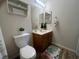 Bathroom features a toilet, single sink vanity and mirrored cabinets at 5904 Oakton St, Las Vegas, NV 89130