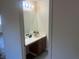 Bathroom features a single sink vanity with wood cabinets and a large mirror at 5904 Oakton St, Las Vegas, NV 89130